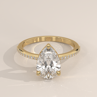 Pavé Band Solitaire in 14k Yellow Gold with a pear cut diamond